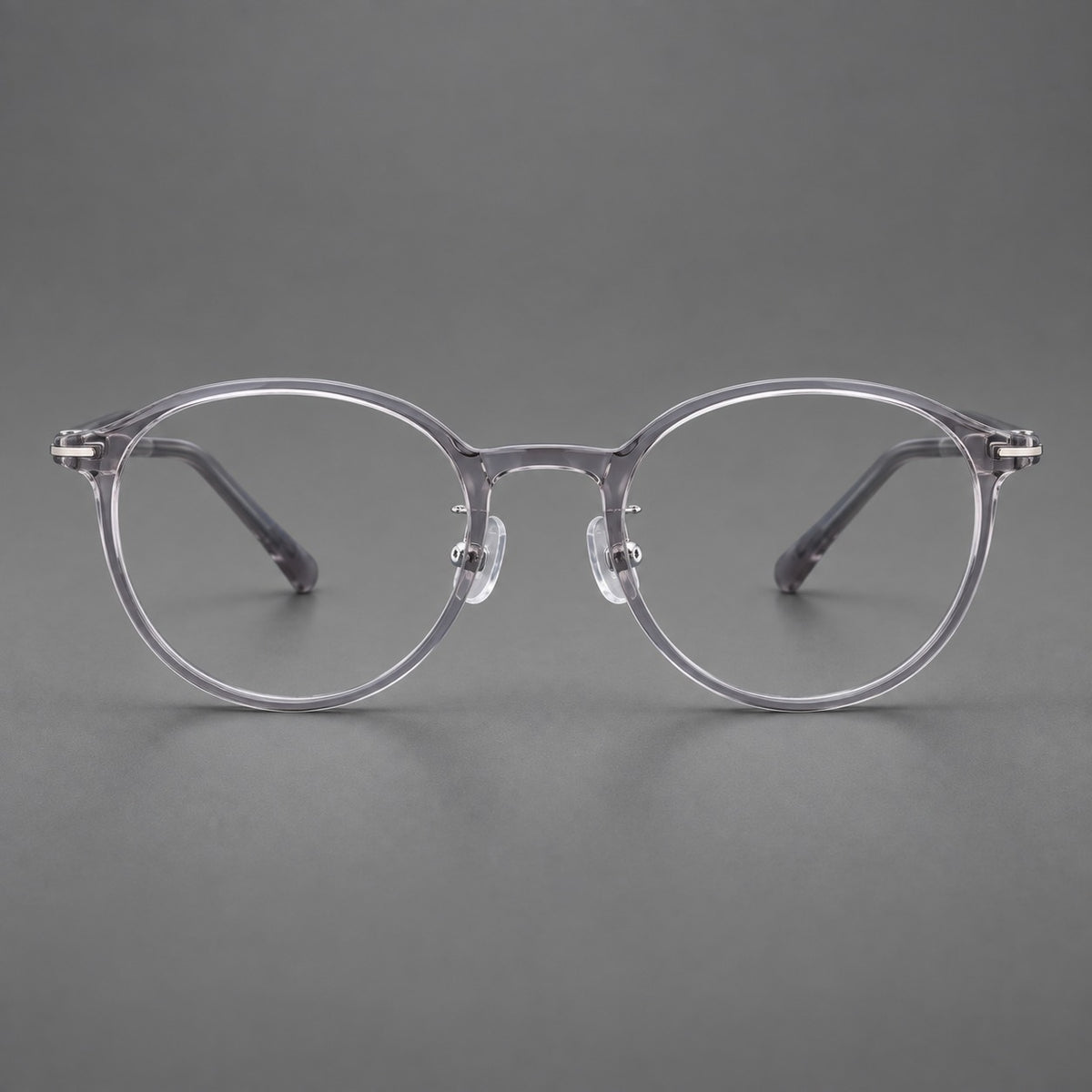 Compact round plastic eyeglasses with gently lifted corners and clear nose pads — Clear Grey — Front view [CINILY-JD2026-2202-C1]