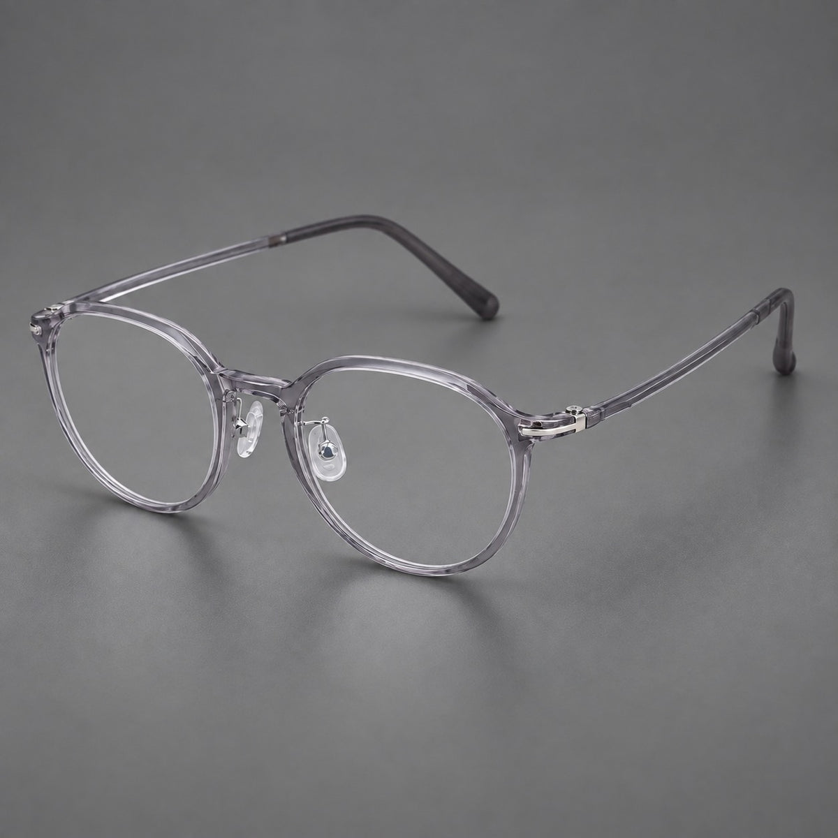 Compact round plastic eyeglasses with gently lifted corners and clear nose pads — Clear Grey — Main view [CINILY-JD2026-2202-C1]