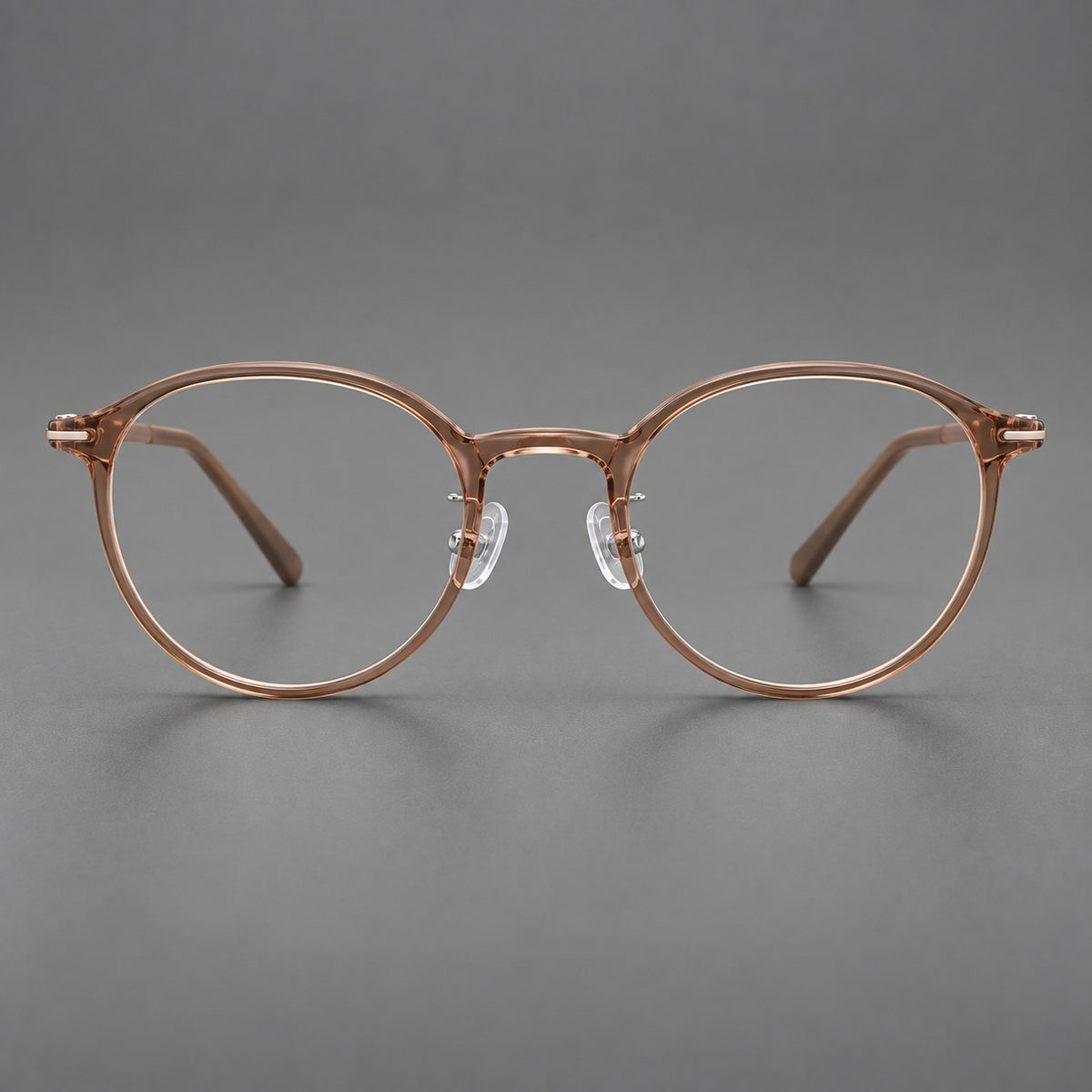 Compact round plastic eyeglasses with gently lifted corners and clear nose pads — Amber Tea — Front view [CINILY-JD2026-2202-C12]