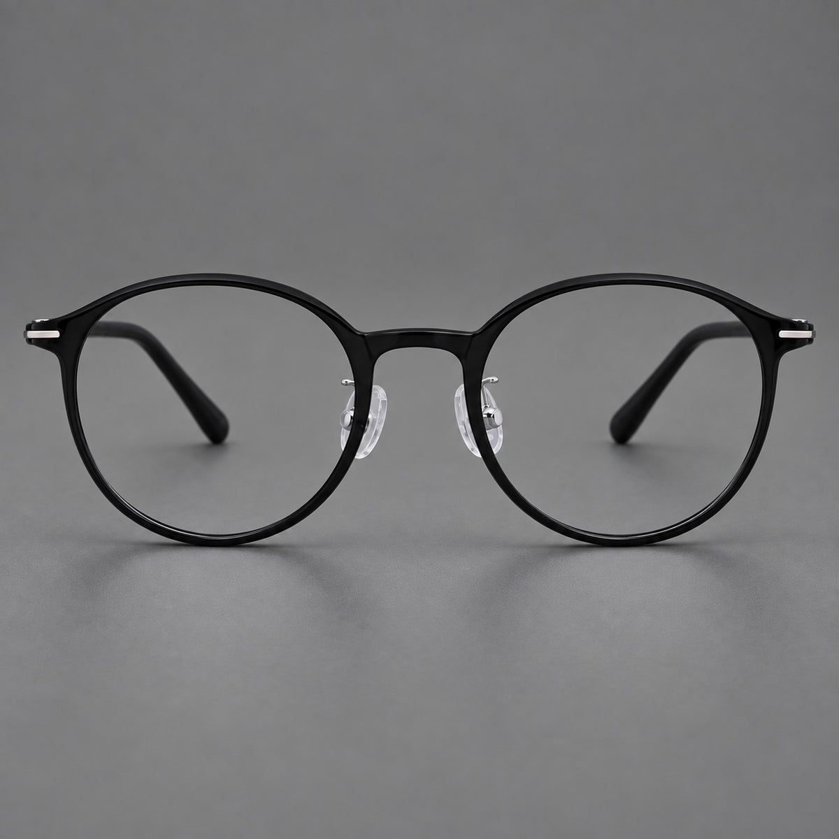 Compact round plastic eyeglasses with gently lifted corners and clear nose pads — Glossy Black — Front view [CINILY-JD2026-2202-C6]