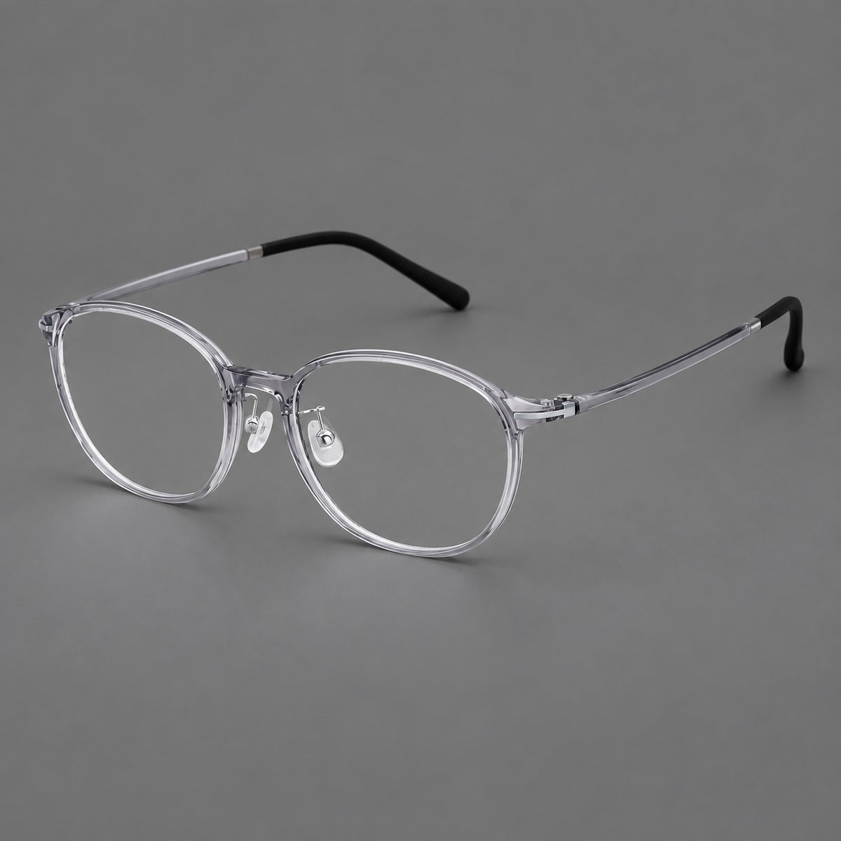 Slim oval plastic eyeglasses with a low profile and subtle metal corner accents — Clear Grey — Main view [CINILY-JD2026-2204-C1]
