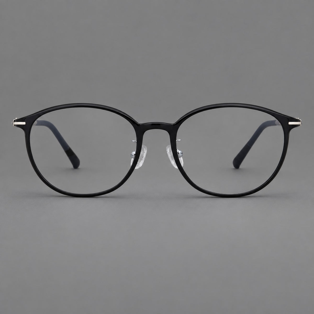 Slim oval plastic eyeglasses with a low profile and subtle metal corner accents — Glossy Black — Front view [CINILY-JD2026-2204-C6]