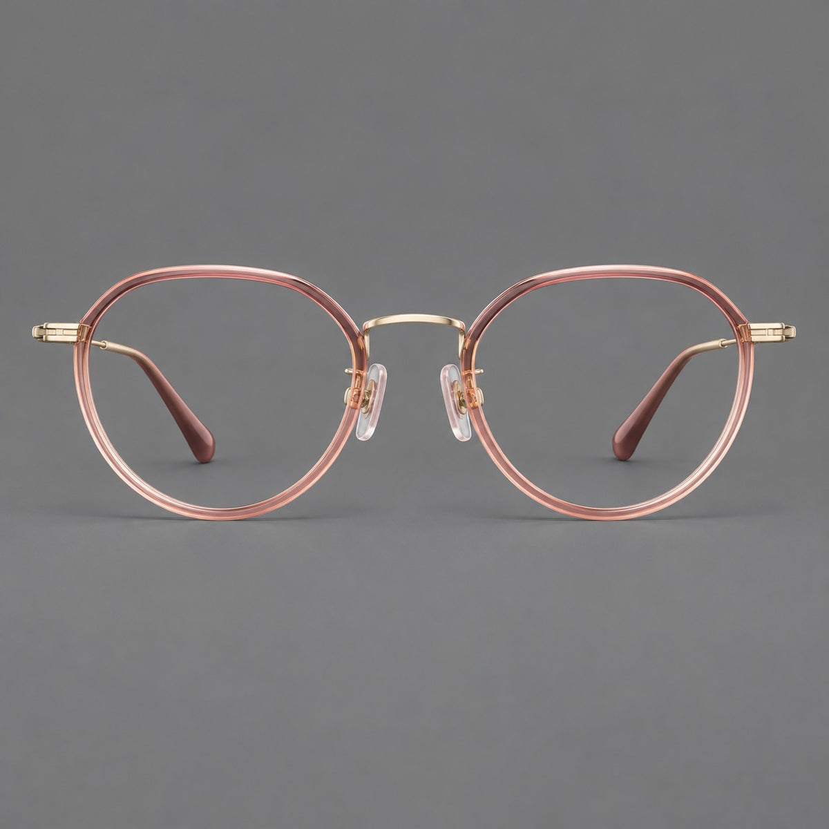 Rounded eyeglasses in acetate and titanium with gently arched brows and engraved metal temples — Amber Pink / Gold — Front view [CINILY-JD2026-61002-C1]
