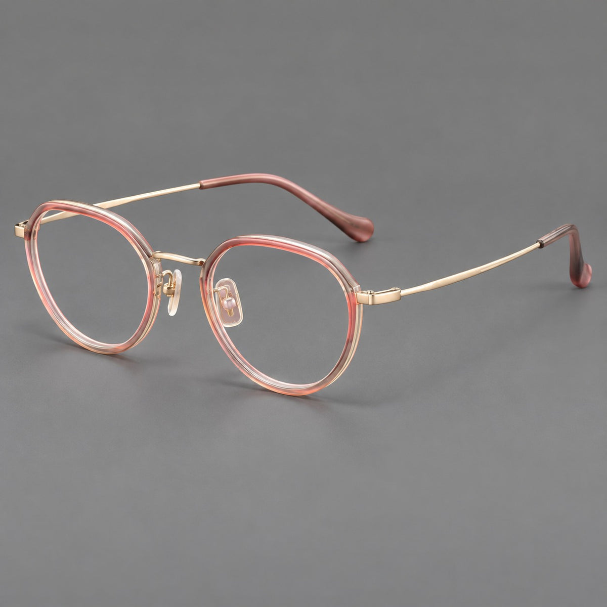 Rounded eyeglasses in acetate and titanium with gently arched brows and engraved metal temples — Amber Pink / Gold — Main view [CINILY-JD2026-61002-C1]