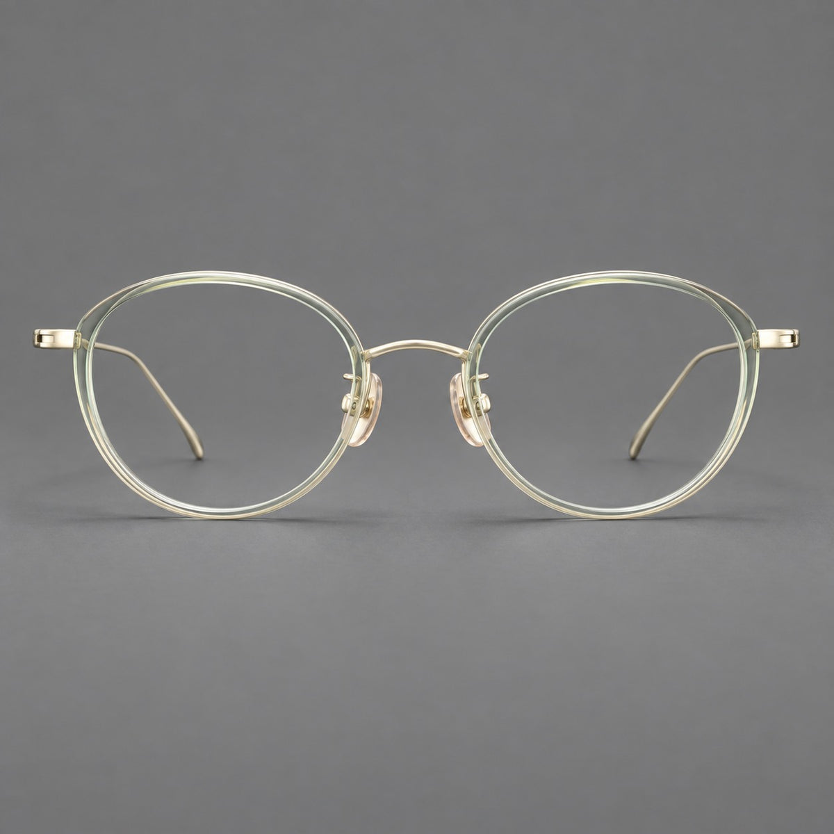 Round eyeglasses in acetate and titanium with a slim curved bridge and fine metal temples — Green / Gold — Front view [CINILY-JD2026-61004-C1]