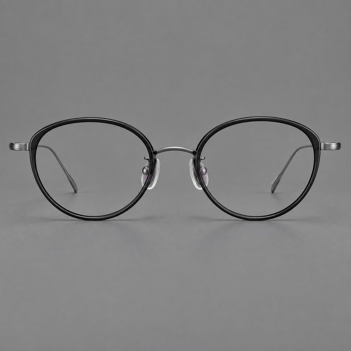 Round eyeglasses in acetate and titanium with a slim curved bridge and fine metal temples — Glossy Black / Gunmetal — Front view [CINILY-JD2026-61004-C6]