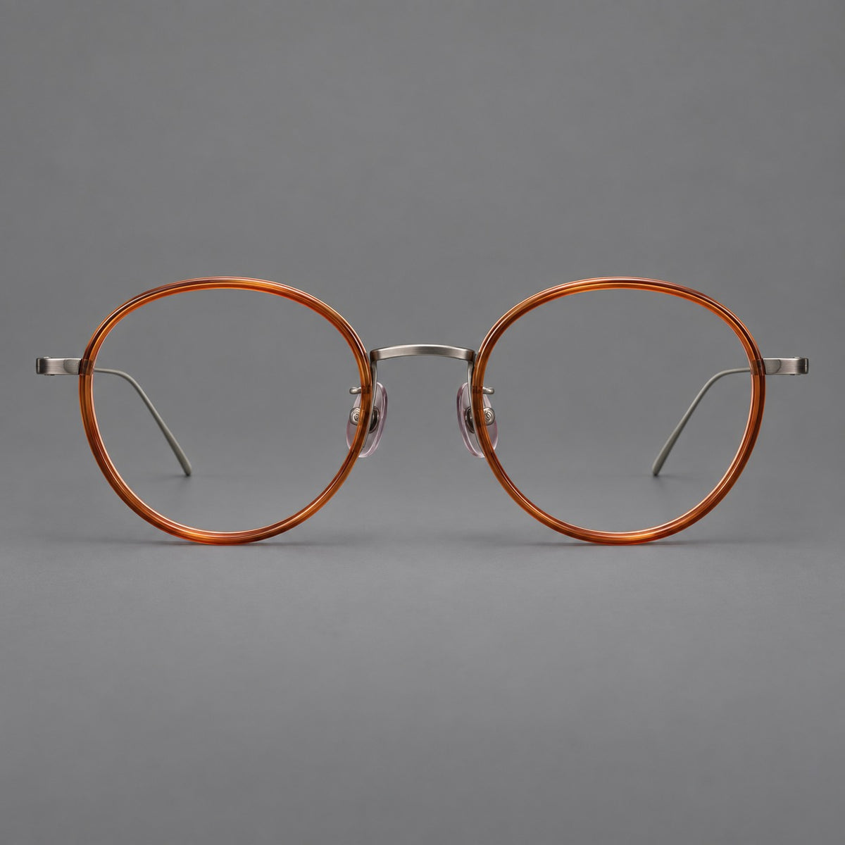 Classic round eyeglasses in acetate and titanium with slim rims and textured metal temples — Tea Brown / Gunmetal — Front view [CINILY-JD2026-61005-C1]