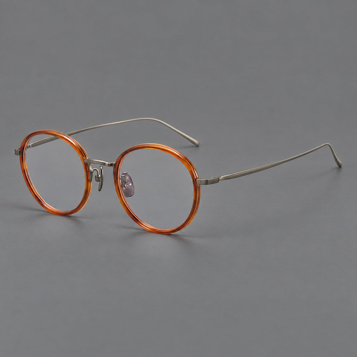 Classic round eyeglasses in acetate and titanium with slim rims and textured metal temples — Tea Brown / Gunmetal — Main view [CINILY-JD2026-61005-C1]