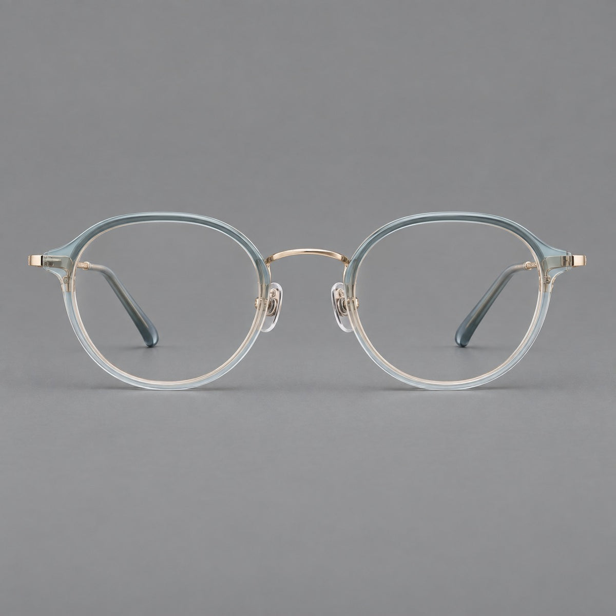Softly rounded eyeglasses in acetate and titanium with a curved bridge and engraved temples — Ice Blue Grey / Gold — Front view [CINILY-JD2026-61007-C1]