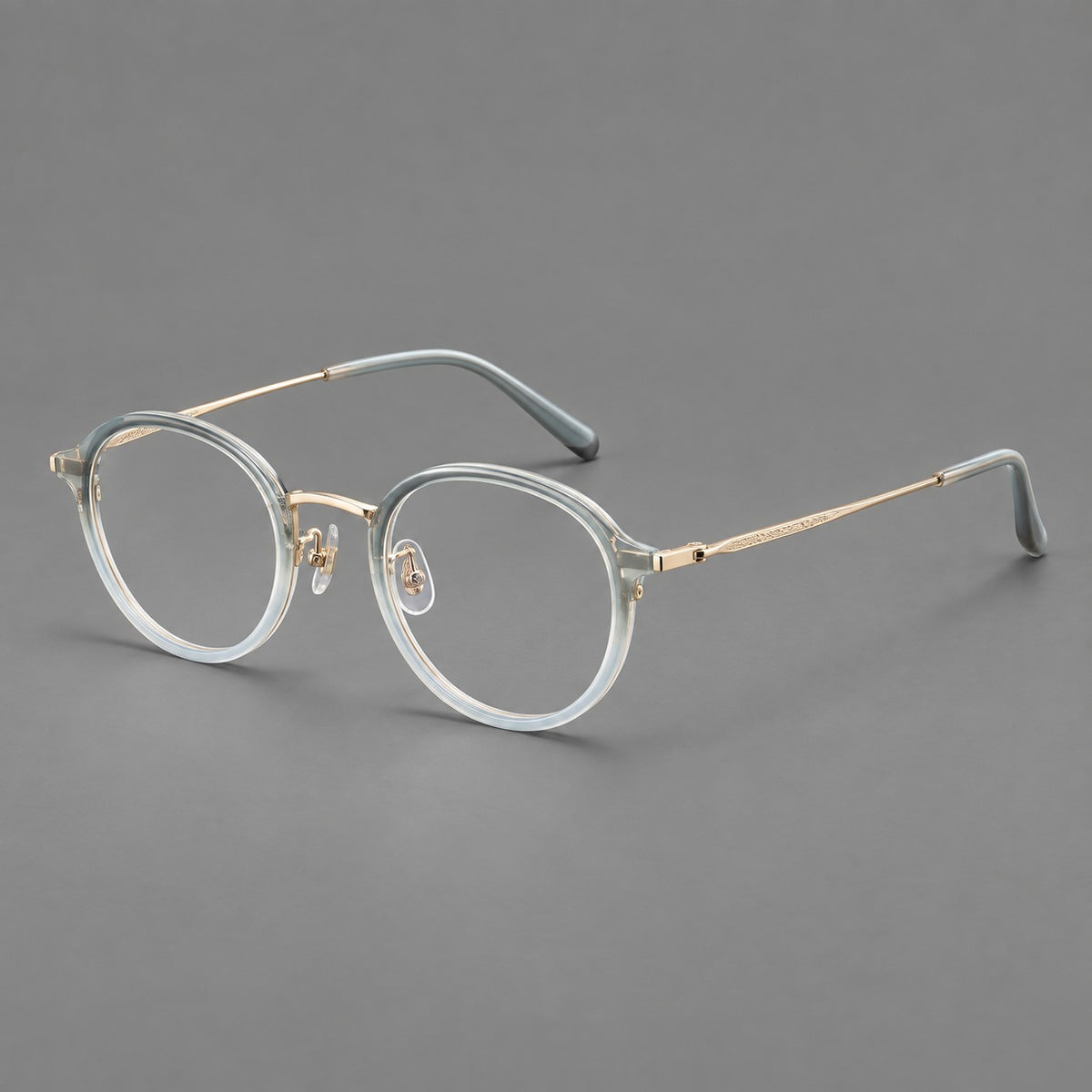 Softly rounded eyeglasses in acetate and titanium with a curved bridge and engraved temples — Ice Blue Grey / Gold — Main view [CINILY-JD2026-61007-C1]