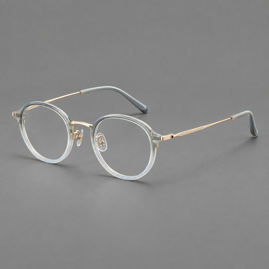 Softly rounded eyeglasses in acetate and titanium with a curved bridge and engraved temples — Ice Blue Grey / Gold — Main view [CINILY-JD2026-61007-C1]