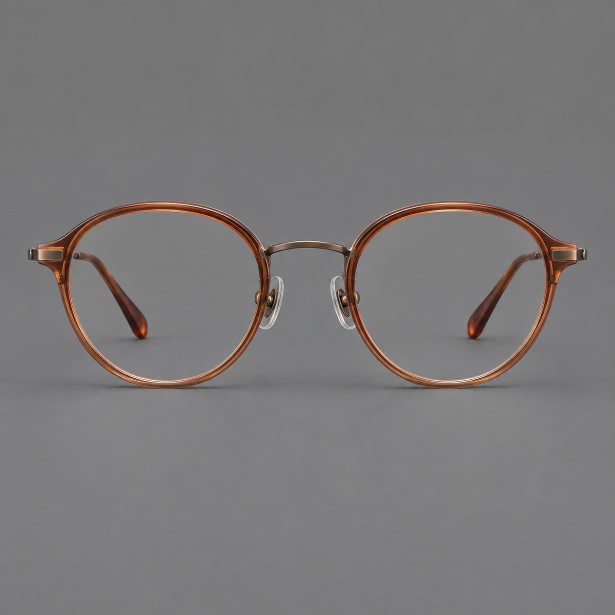 Softly rounded eyeglasses in acetate and titanium with a curved bridge and engraved temples — Tea Brown / Antique Bronze — Front view [CINILY-JD2026-61007-C2]