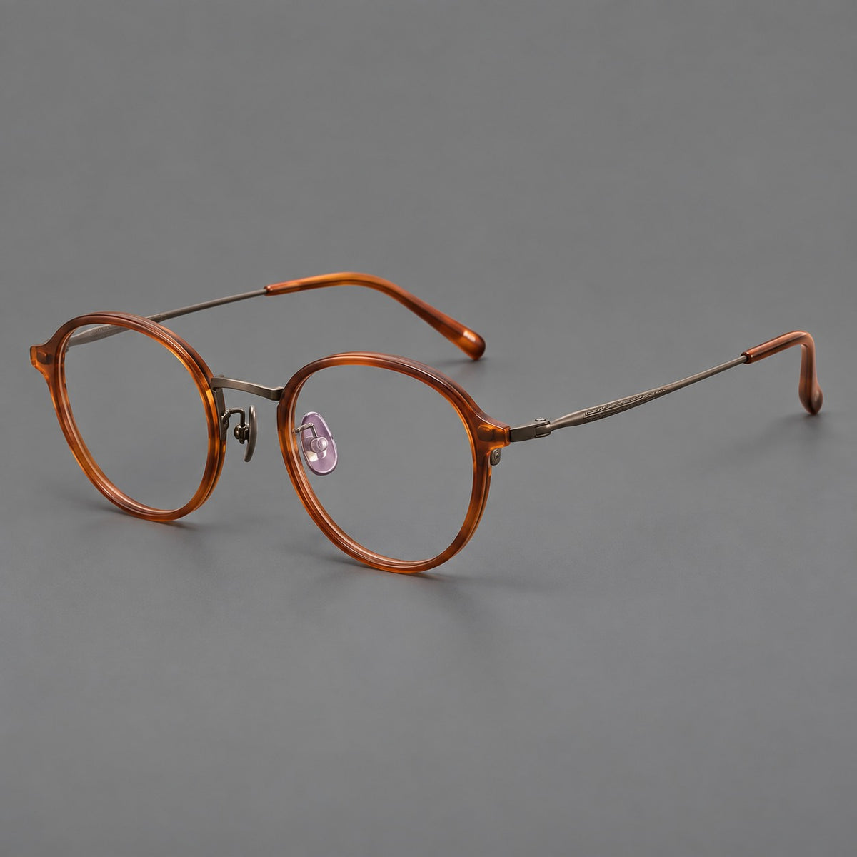 Softly rounded eyeglasses in acetate and titanium with a curved bridge and engraved temples — Tea Brown / Antique Bronze — Main view [CINILY-JD2026-61007-C2]