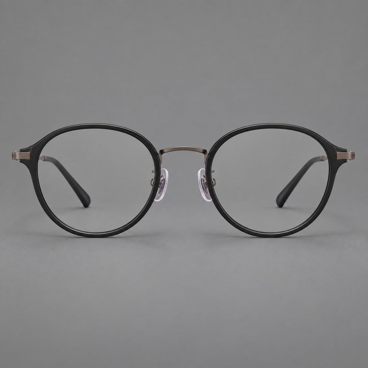 Softly rounded eyeglasses in acetate and titanium with a curved bridge and engraved temples — Matte Black / Antique Copper — Front view [CINILY-JD2026-61007-C5]