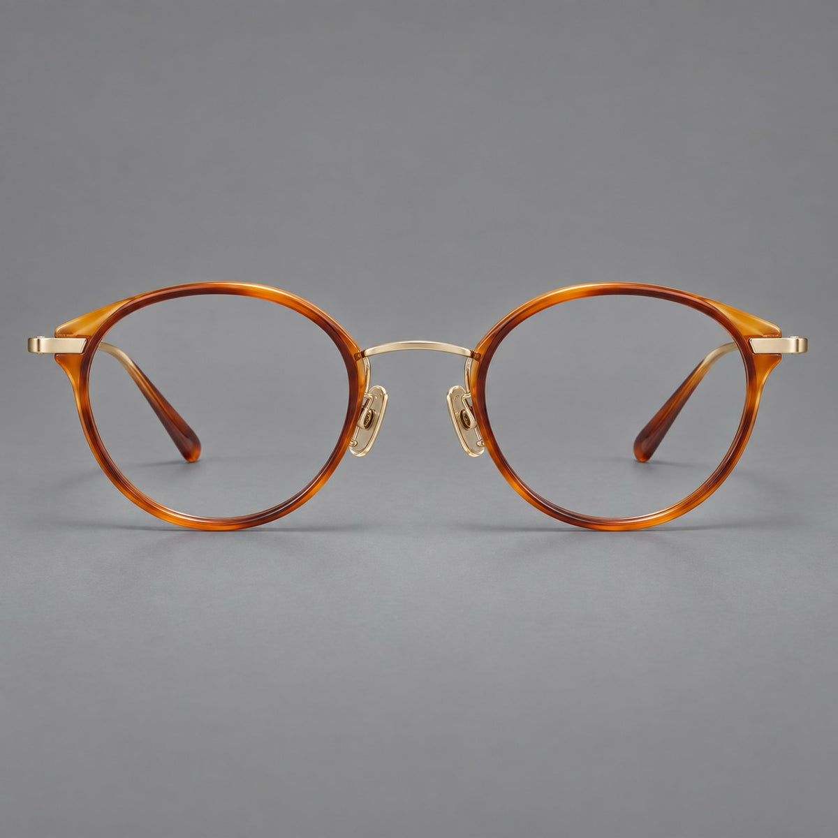 Retro panto eyeglasses in acetate and titanium with an arched bridge and engraved metal temples — Amber Tortoiseshell / Light Gold — Front view [CINILY-JD2026-61009-C1]