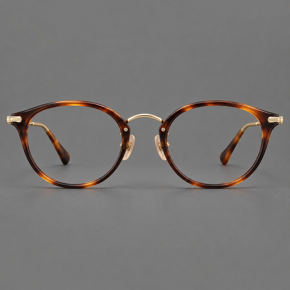 Vintage panto eyeglasses in acetate and titanium with raised brows and textured metal temples — Tortoiseshell / Gold — Front view [CINILY-JD2026-61017-C1]