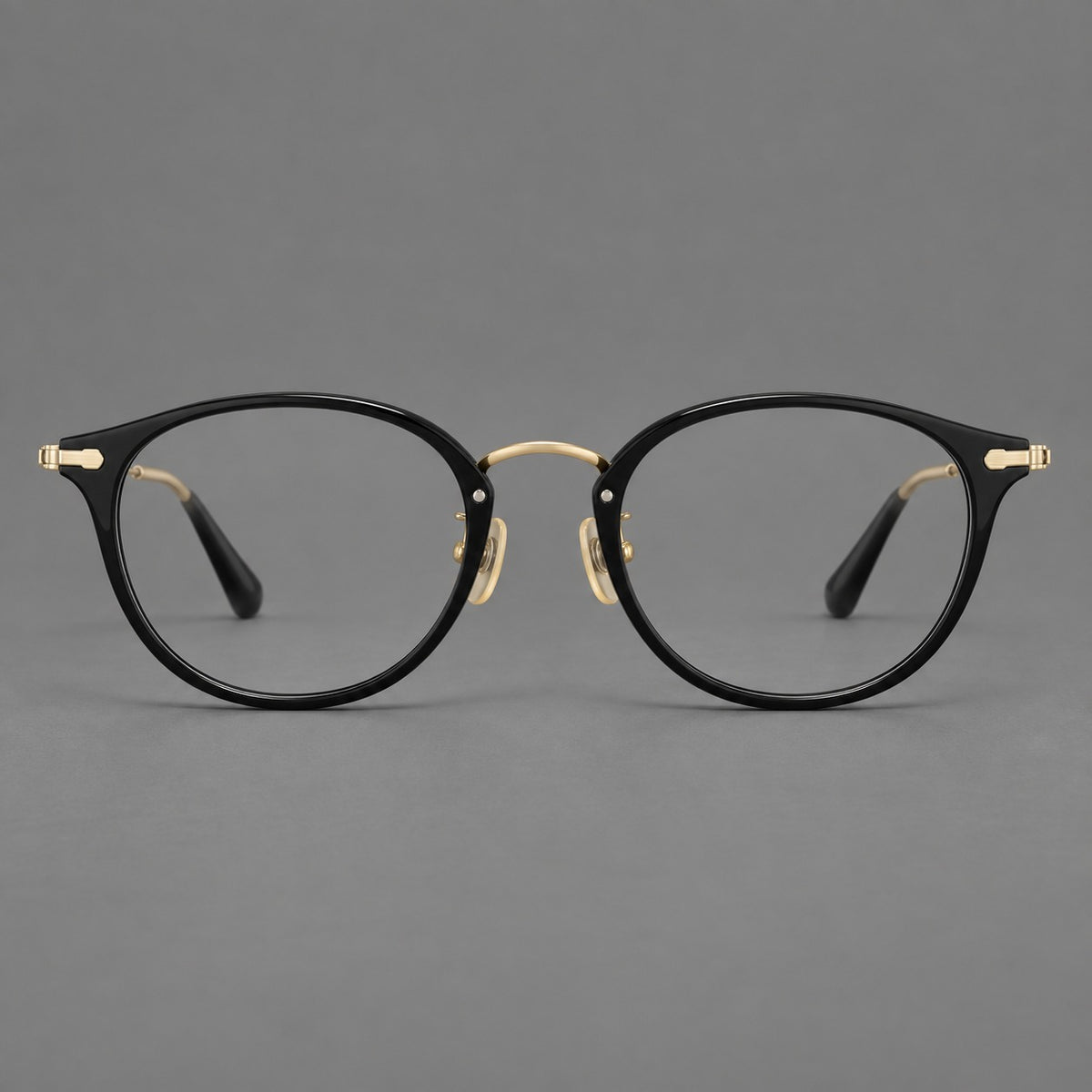 Vintage panto eyeglasses in acetate and titanium with raised brows and textured metal temples — Glossy Black / Gold — Front view [CINILY-JD2026-61017-C3]