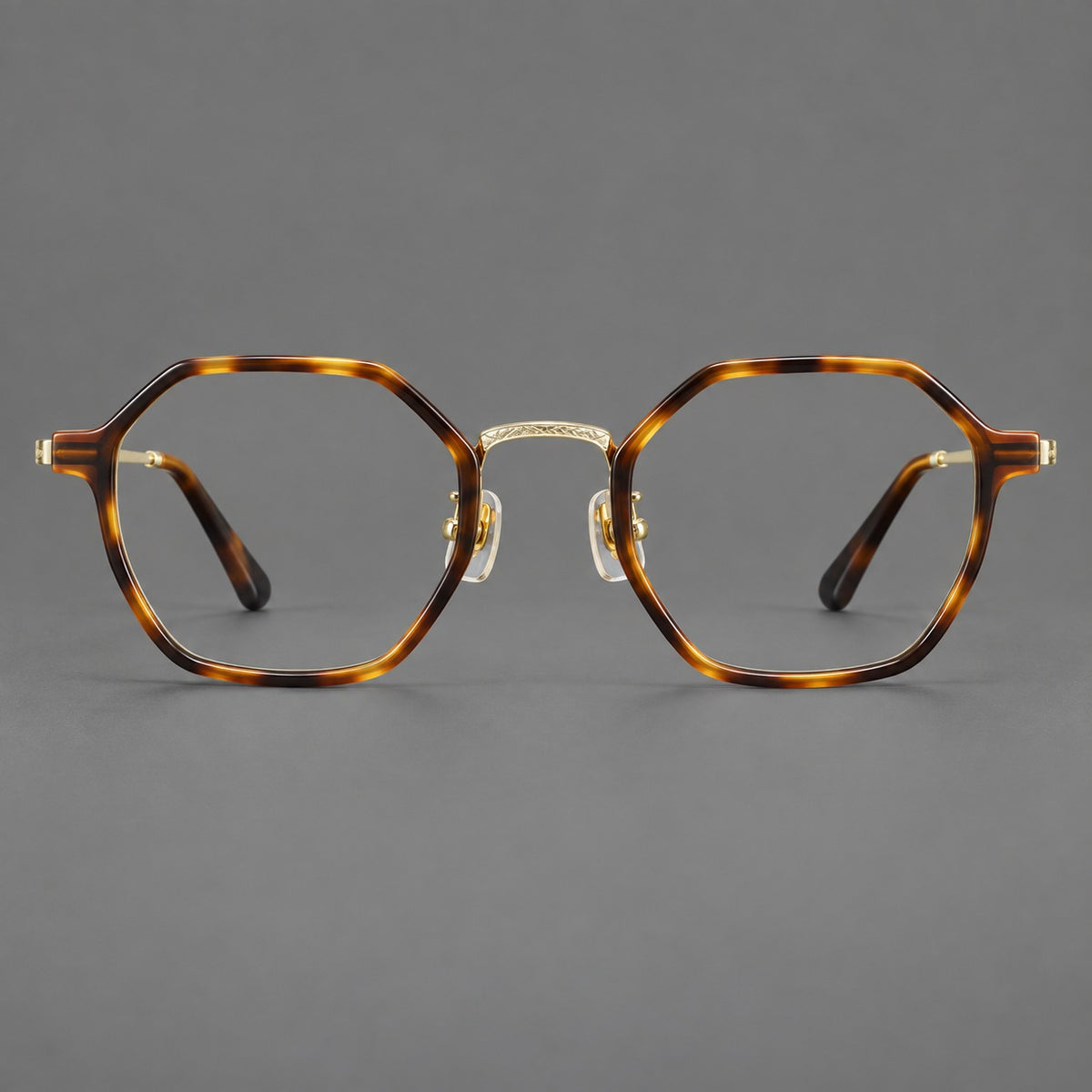 Geometric eyeglasses in acetate and titanium with octagonal rims and a textured metal bridge — Amber Tortoiseshell / Light Gold — Front view [CINILY-JD2026-61027-C1]