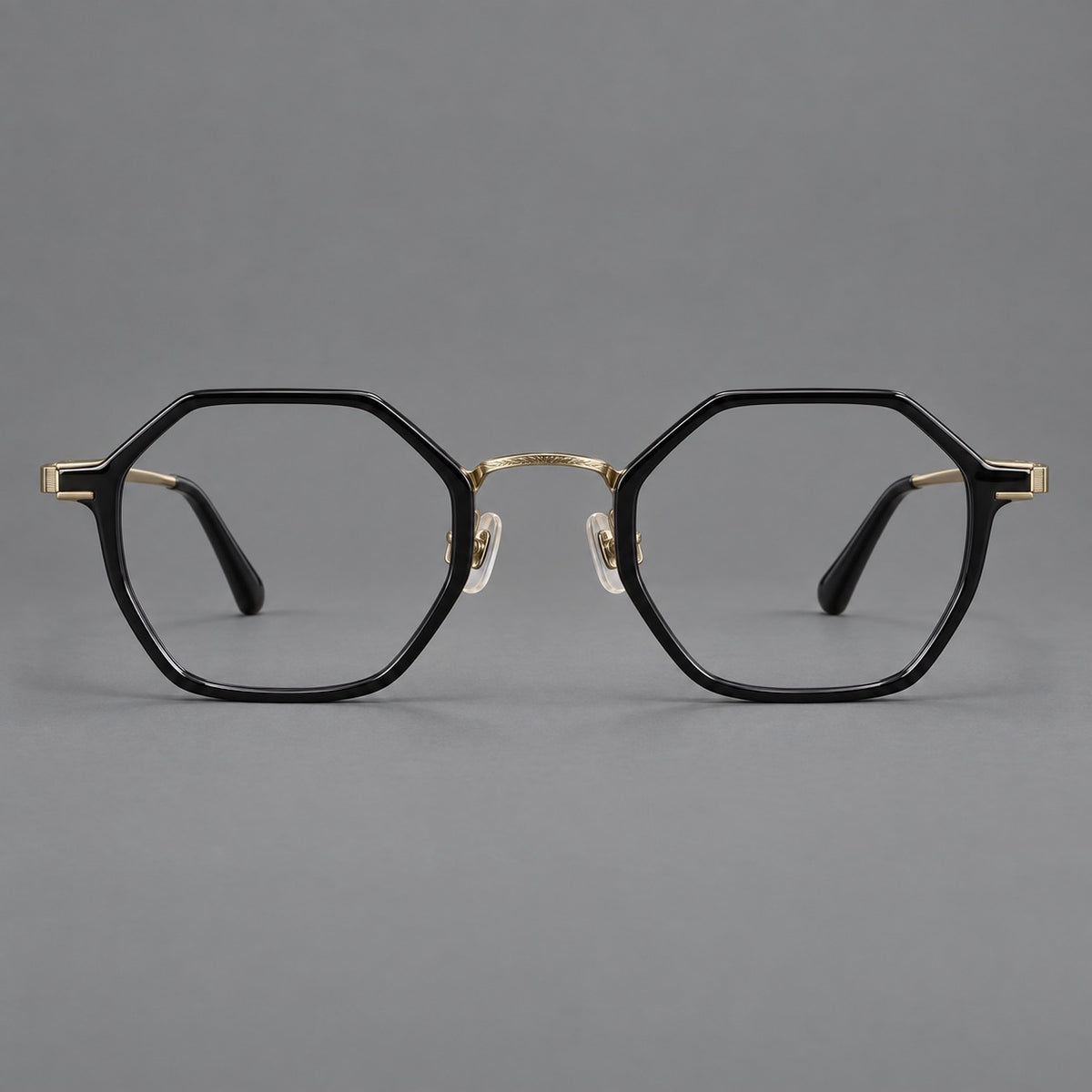 Geometric eyeglasses in acetate and titanium with octagonal rims and a textured metal bridge — Glossy Black / Antique Gold — Front view [CINILY-JD2026-61027-C3]