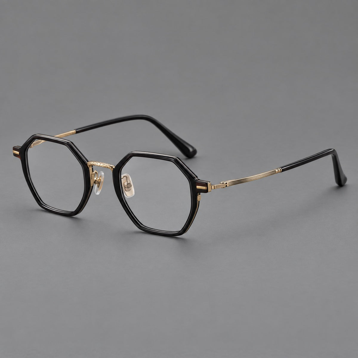 Geometric eyeglasses in acetate and titanium with octagonal rims and a textured metal bridge — Glossy Black / Antique Gold — Main view [CINILY-JD2026-61027-C3]