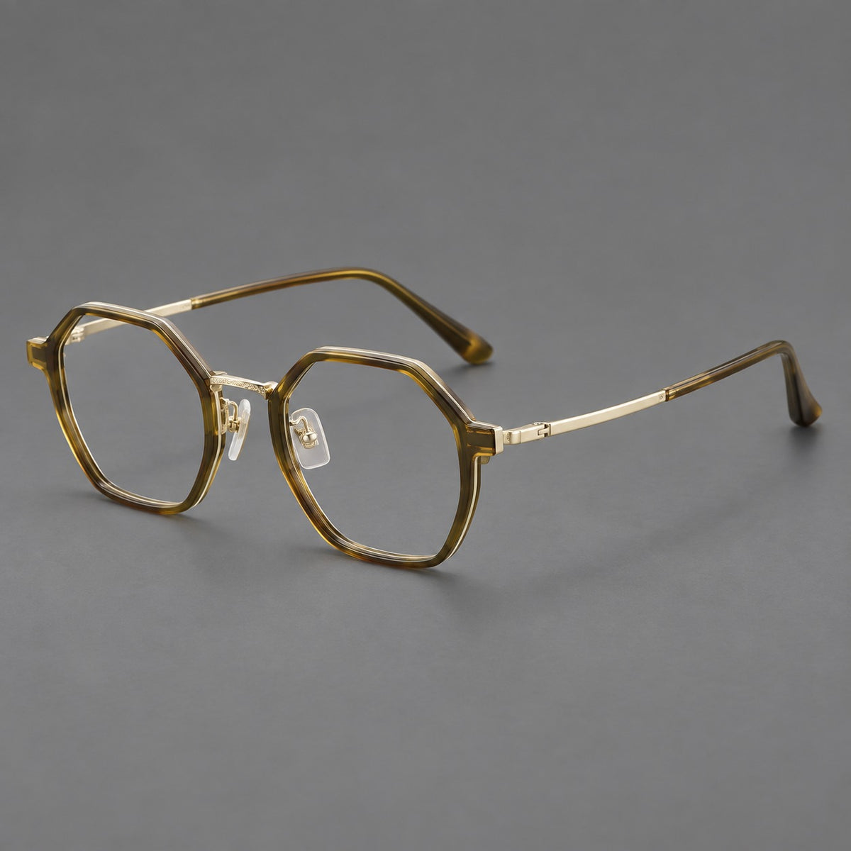 Geometric eyeglasses in acetate and titanium with octagonal rims and a textured metal bridge — Clear Tea Green / Light Gold — Main view [CINILY-JD2026-61027-C5]