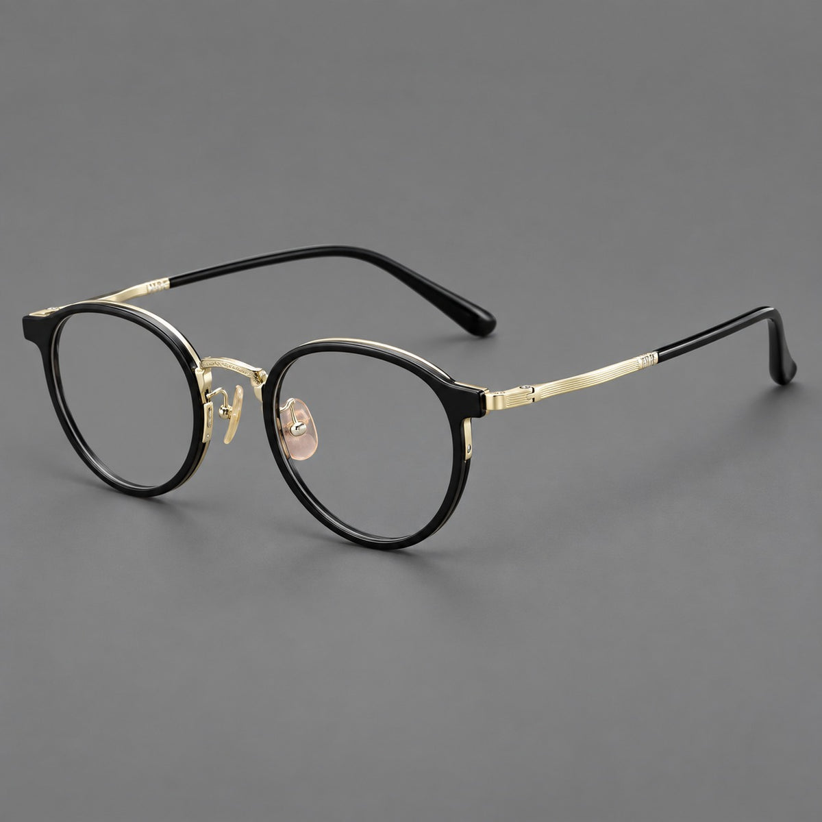 Round eyeglasses in acetate and titanium with widened outer corners and slender metal temples — Glossy Black / Gold — Main view [CINILY-JD2026-61028-C3]