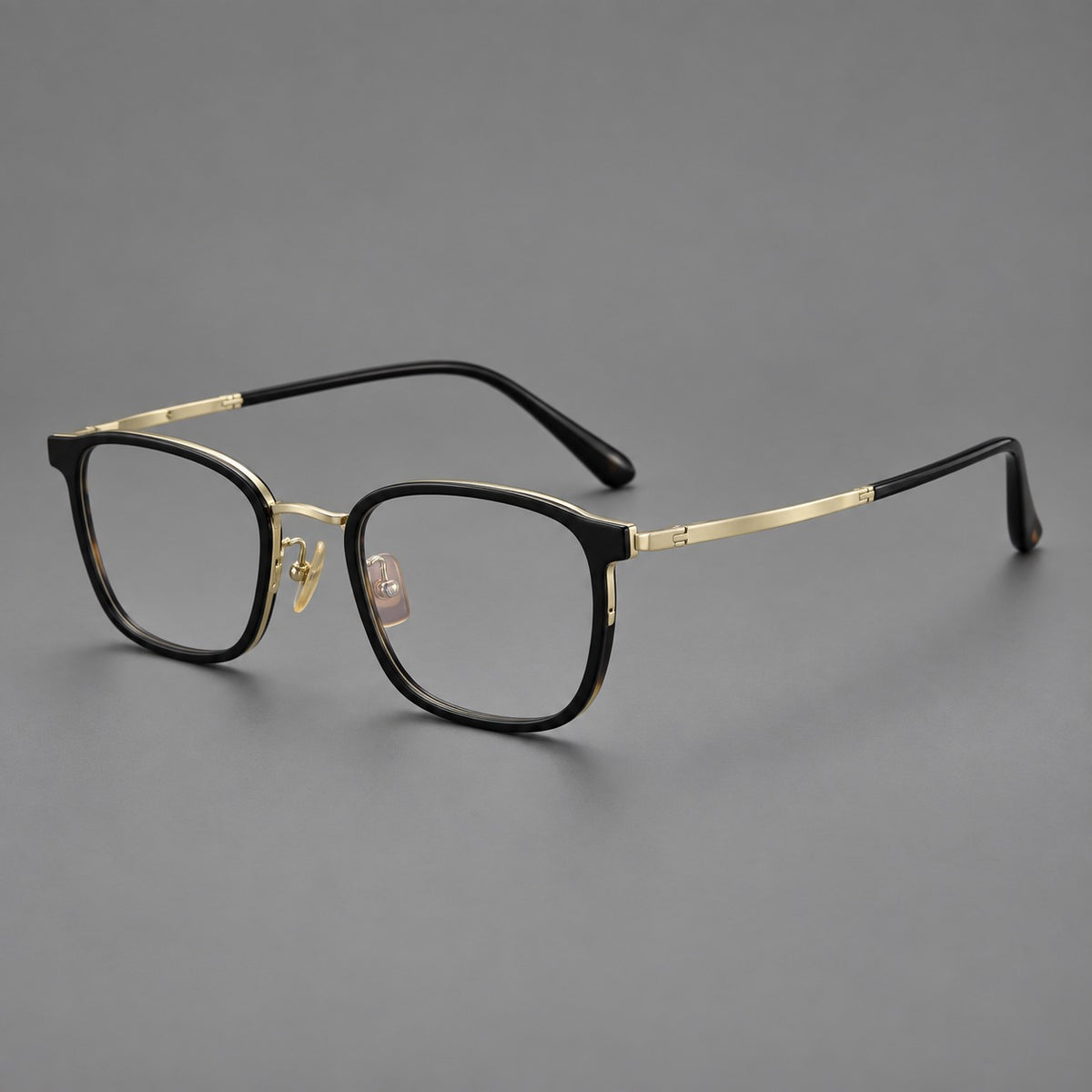 Rounded rectangular eyeglasses in acetate and titanium with bold corners and engraved metal temples — Glossy Black / Gold — Main view [CINILY-JD2026-61029-C3]