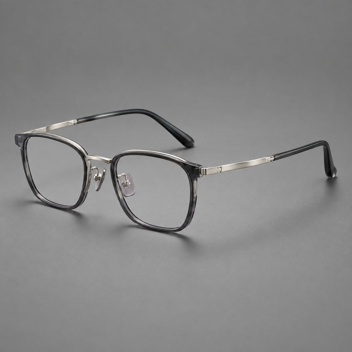 Rounded rectangular eyeglasses in acetate and titanium with bold corners and engraved metal temples — Clear Grey / Gunmetal — Main view [CINILY-JD2026-61029-C6]