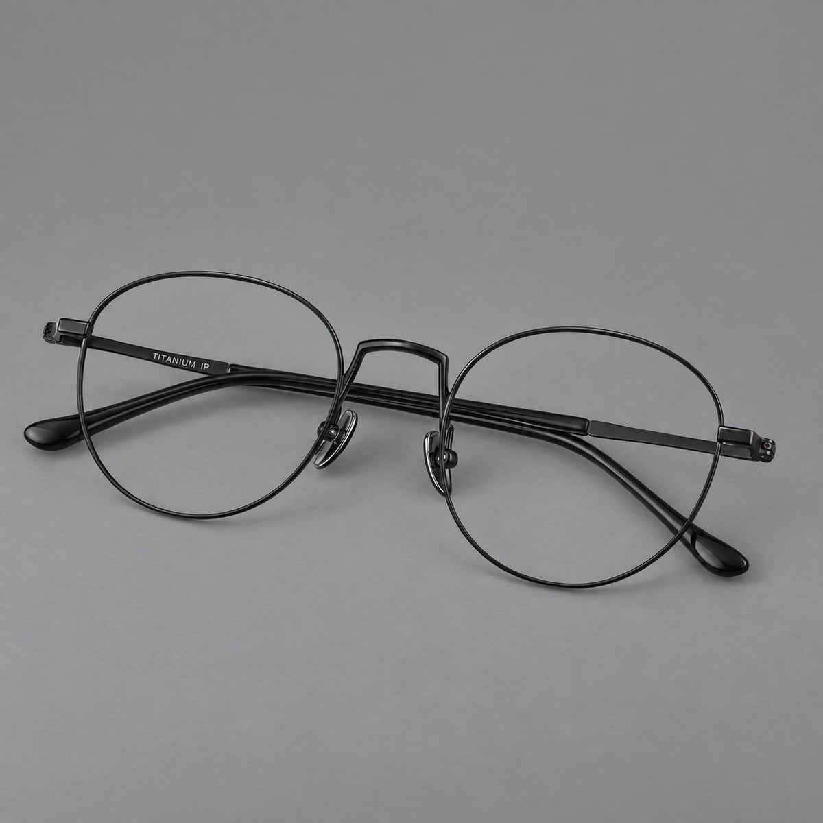 Retro round titanium glasses with a raised bridge and smooth corner shoulders — Black — Main view [CINILY-JD2026-88006-C1]