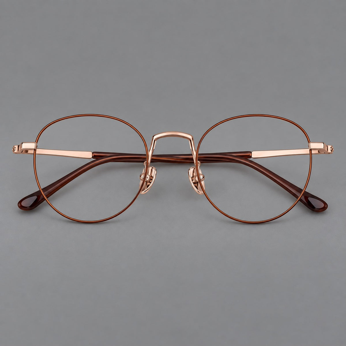 Retro round titanium glasses with a raised bridge and smooth corner shoulders — Brown and Rose Gold — Front view [CINILY-JD2026-88006-C2]