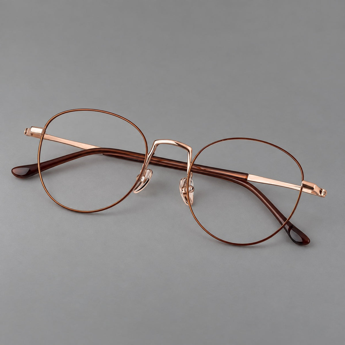 Retro round titanium glasses with a raised bridge and smooth corner shoulders — Brown and Rose Gold — Main view [CINILY-JD2026-88006-C2]