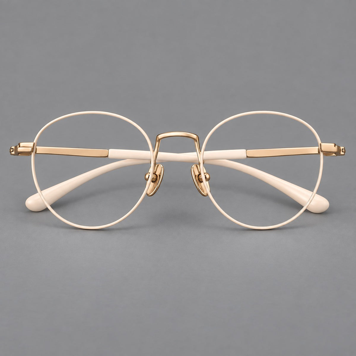 Retro round titanium glasses with a raised bridge and smooth corner shoulders — Cream and Gold — Front view [CINILY-JD2026-88006-C3]
