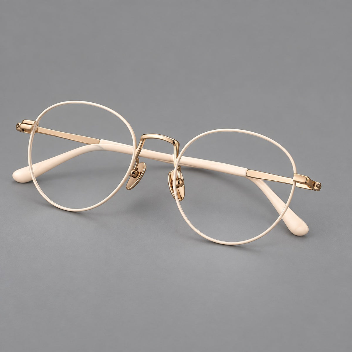 Retro round titanium glasses with a raised bridge and smooth corner shoulders — Cream and Gold — Main view [CINILY-JD2026-88006-C3]