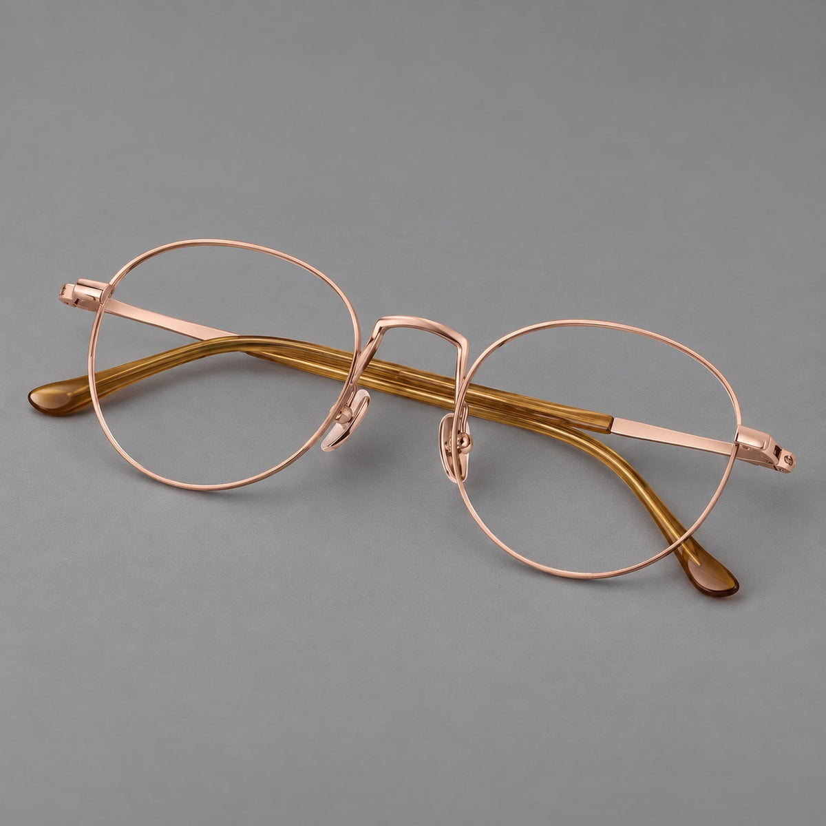 Retro round titanium glasses with a raised bridge and smooth corner shoulders — Rose Gold — Main view [CINILY-JD2026-88006-C5]