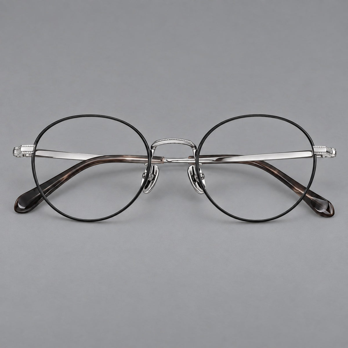 Rounded panto titanium glasses with a raised bridge and dotted temple accents — Black and Silver — Front view [CINILY-JD2026-88017-C3]