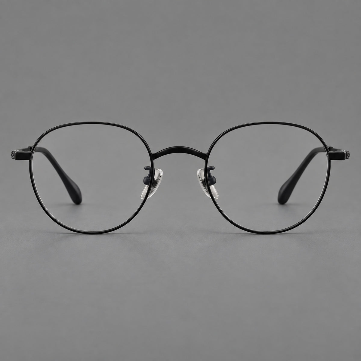 Compact round titanium glasses with an arched bridge and textured temple accents — Black — Front view [CINILY-JD2026-88027-C1]