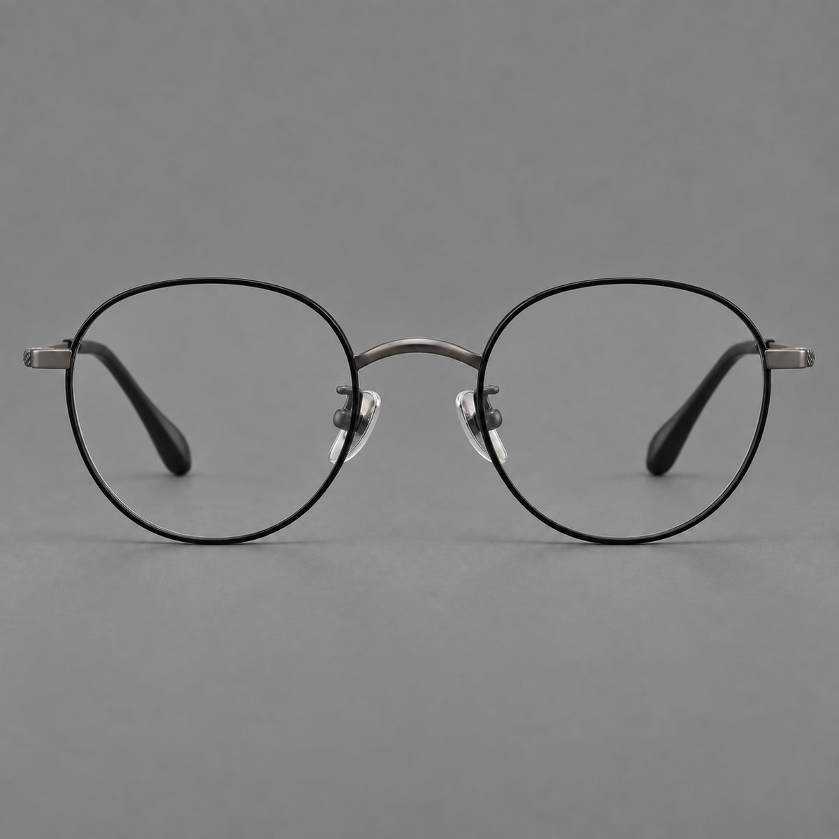 Compact round titanium glasses with an arched bridge and textured temple accents — Black and Gunmetal — Front view [CINILY-JD2026-88027-C2]