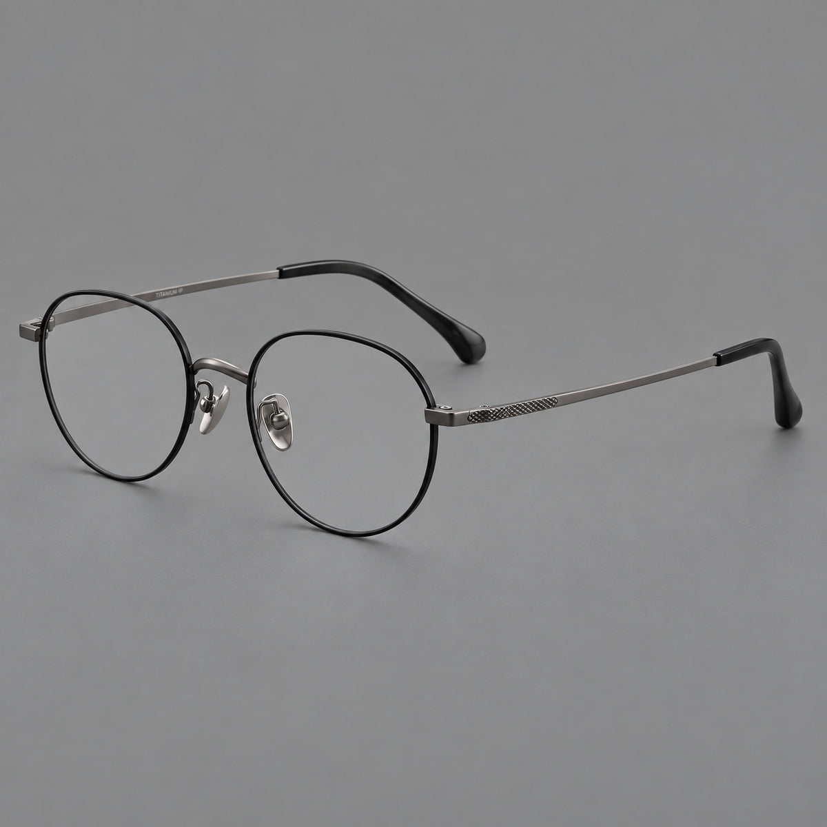 Compact round titanium glasses with an arched bridge and textured temple accents — Black and Gunmetal — Main view [CINILY-JD2026-88027-C2]