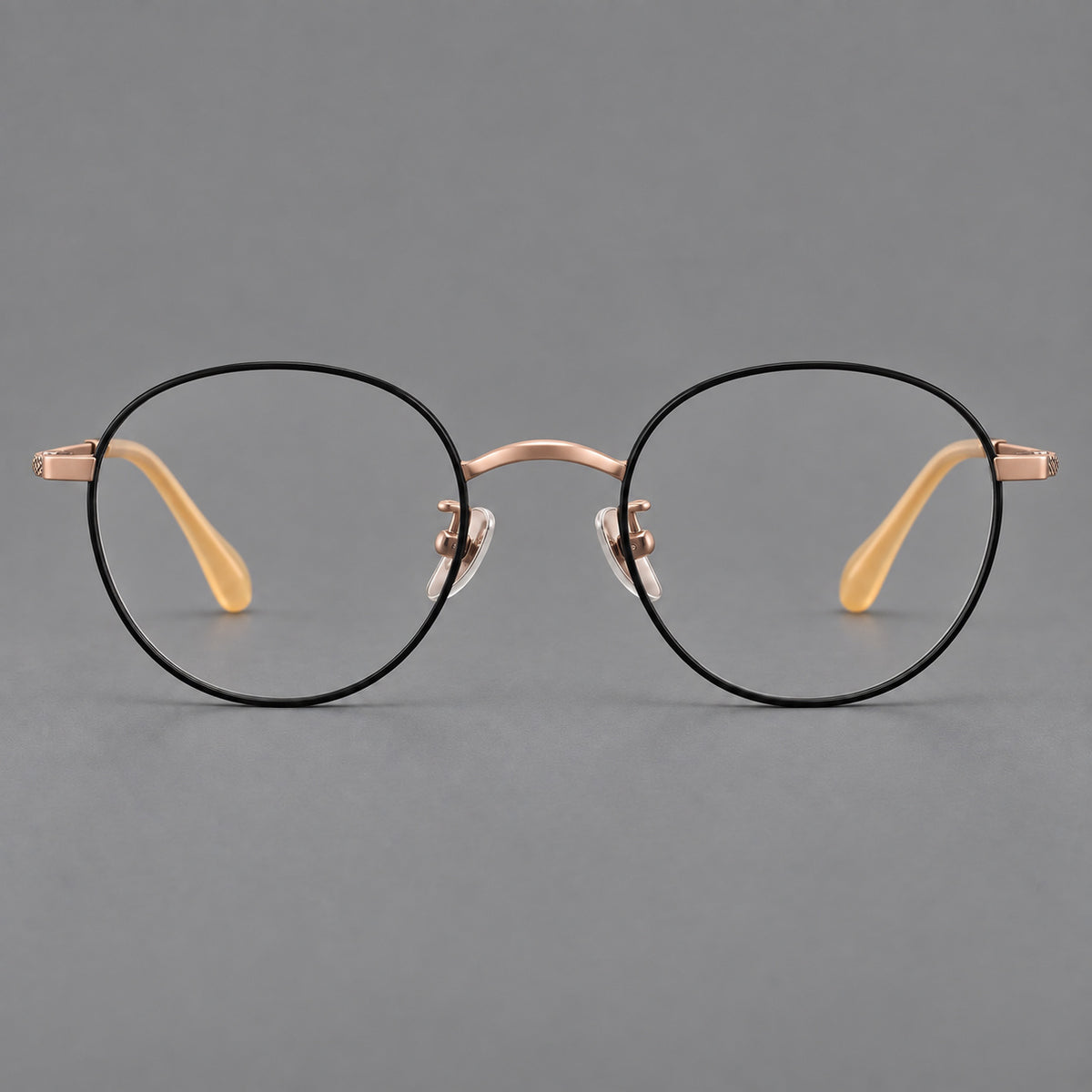 Compact round titanium glasses with an arched bridge and textured temple accents — Black and Rose Gold — Front view [CINILY-JD2026-88027-C3]