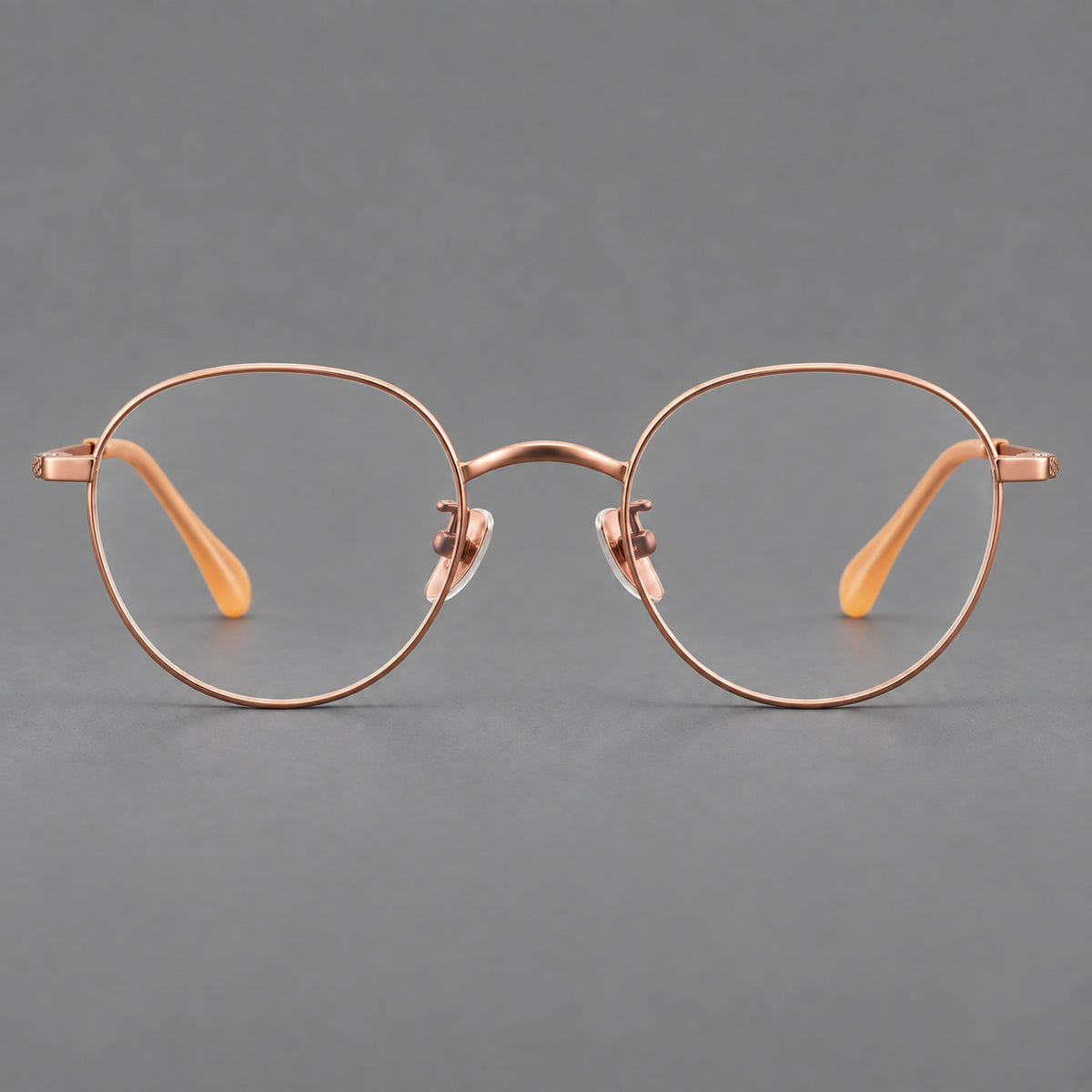 Compact round titanium glasses with an arched bridge and textured temple accents — Rose Gold — Front view [CINILY-JD2026-88027-C5]