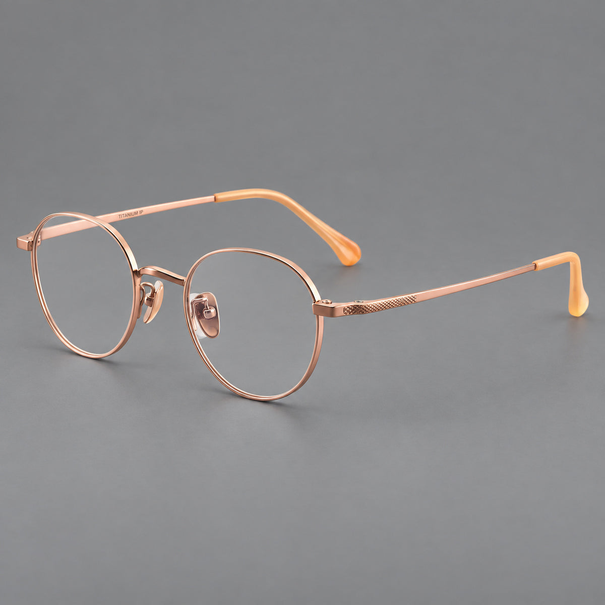 Compact round titanium glasses with an arched bridge and textured temple accents — Rose Gold — Main view [CINILY-JD2026-88027-C5]