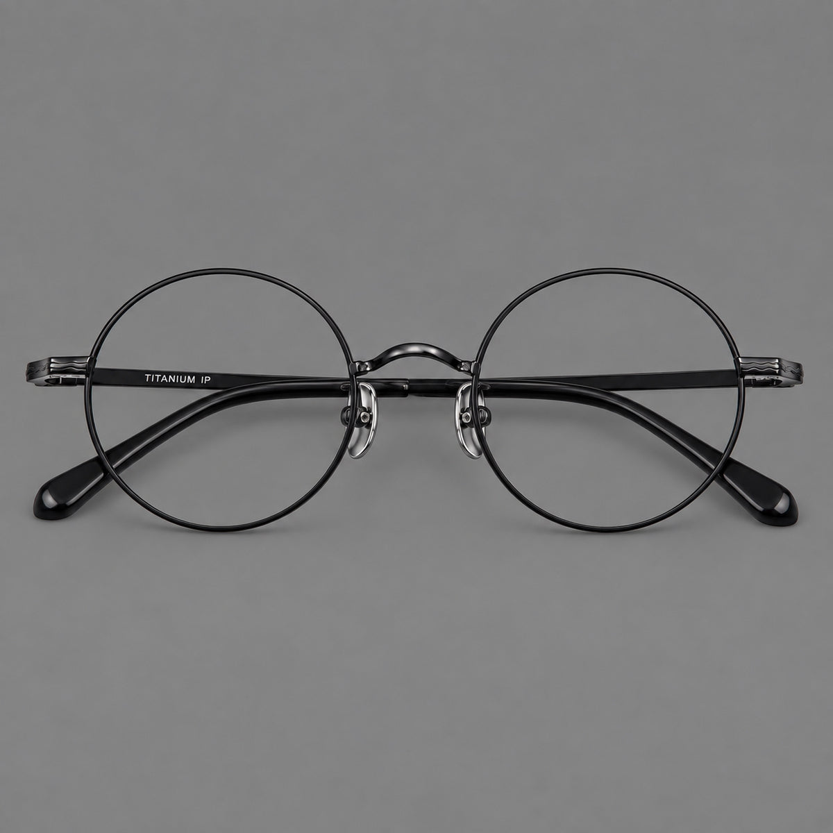 Compact circular titanium glasses with a curved bridge and wavy engraved temples — Black — Front view [CINILY-JD2026-88047-C1]