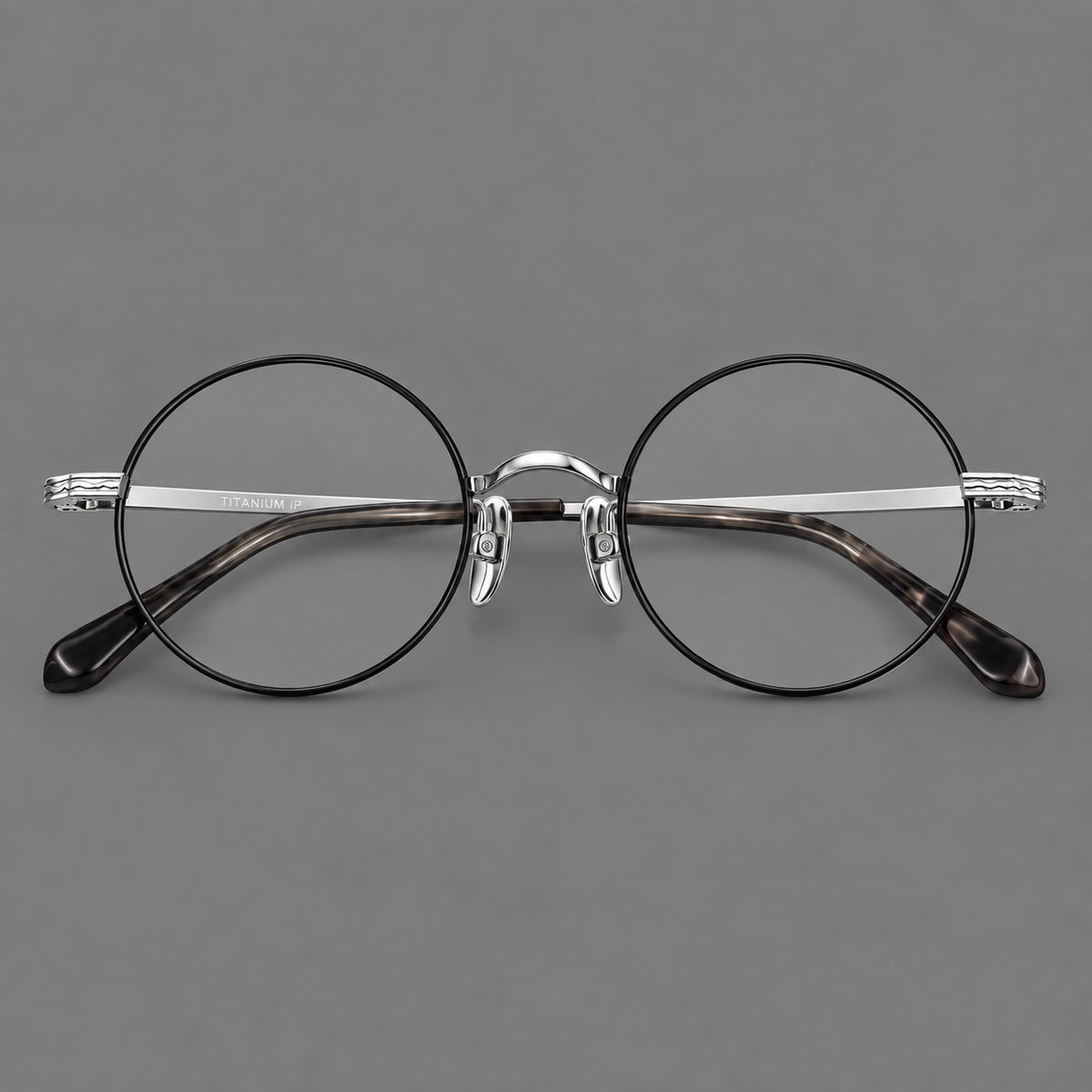 Compact circular titanium glasses with a curved bridge and wavy engraved temples — Black and Silver — Front view [CINILY-JD2026-88047-C3]