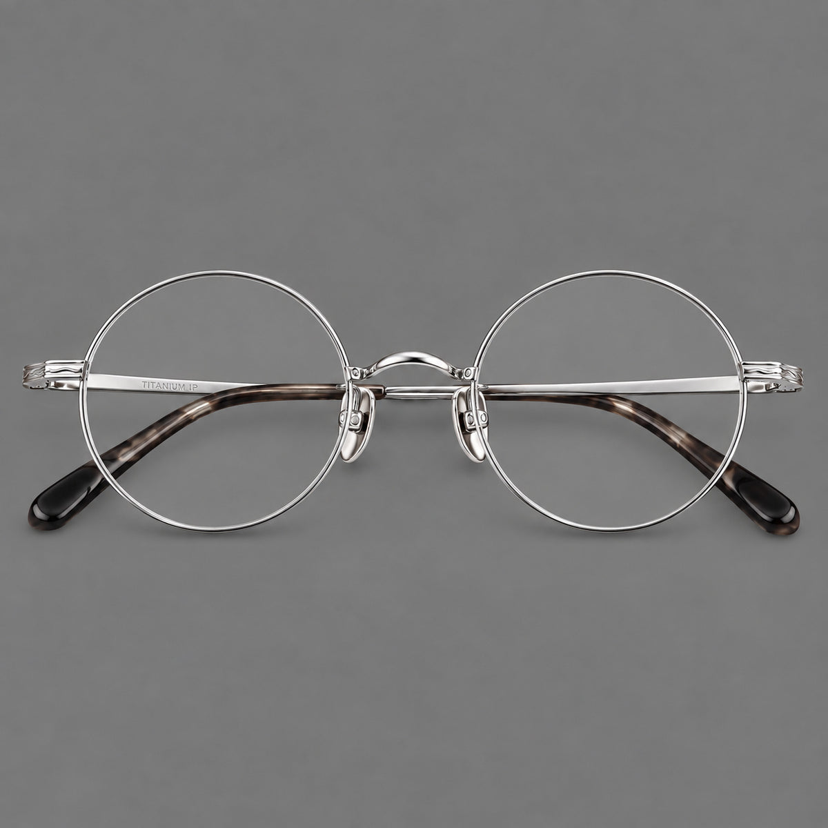 Compact circular titanium glasses with a curved bridge and wavy engraved temples — Silver — Front view [CINILY-JD2026-88047-C4]