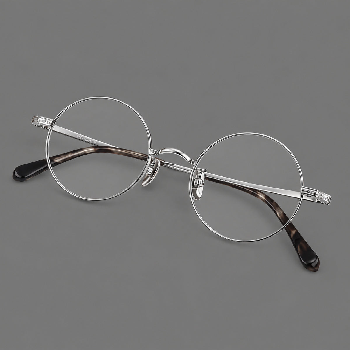 Compact circular titanium glasses with a curved bridge and wavy engraved temples — Silver — Main view [CINILY-JD2026-88047-C4]