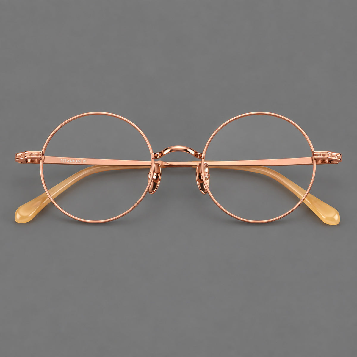 Compact circular titanium glasses with a curved bridge and wavy engraved temples — Rose Gold — Front view [CINILY-JD2026-88047-C5]