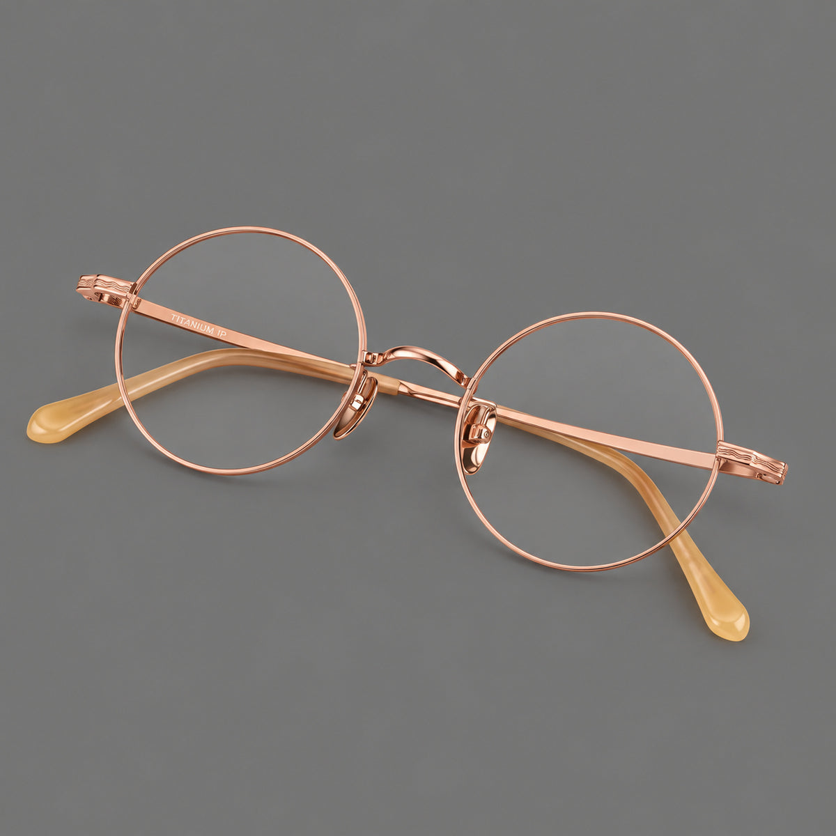 Compact circular titanium glasses with a curved bridge and wavy engraved temples — Rose Gold — Main view [CINILY-JD2026-88047-C5]