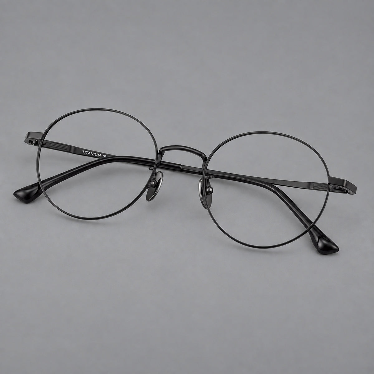 Classic circular titanium glasses with a raised bridge and lined temple accents — Black — Main view [CINILY-JD2026-88049-C1]