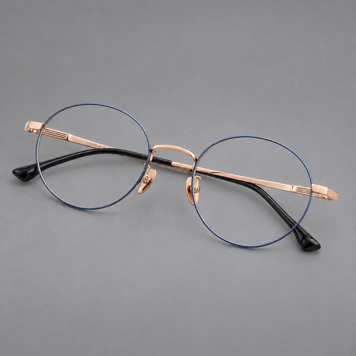 Classic circular titanium glasses with a raised bridge and lined temple accents — Blue and Gold — Main view [CINILY-JD2026-88049-C2]