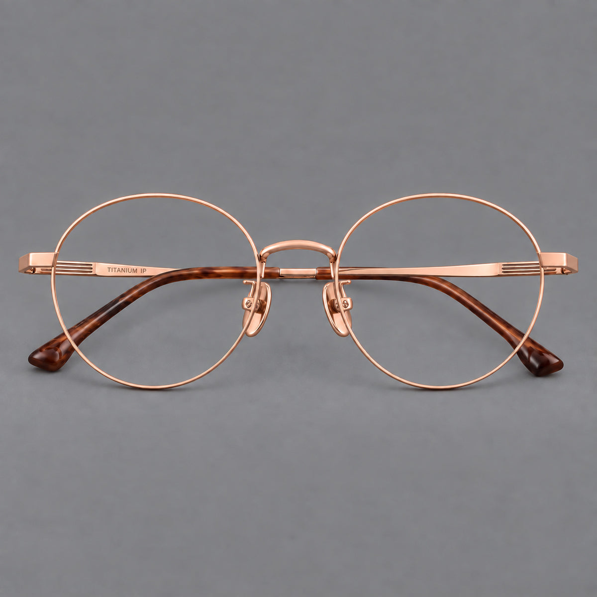 Classic circular titanium glasses with a raised bridge and lined temple accents — Rose Gold — Front view [CINILY-JD2026-88049-C5]